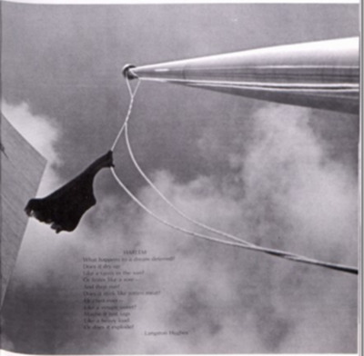 Scanned image from NIU Yearbook of a black flag being raised outside of the Carl Sandberg Auditorium with a poem on the bottom of the image. 
