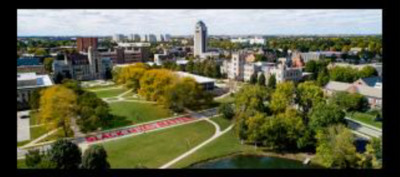 Aerial photograph of NIU campus with Black Lives Matter painted brightly in red along one of the streets on campus. 